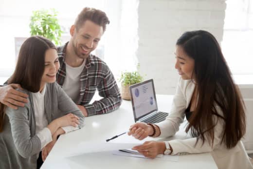 Asian Real Estate Agent, insurance broker or financial advisor consulting young couple