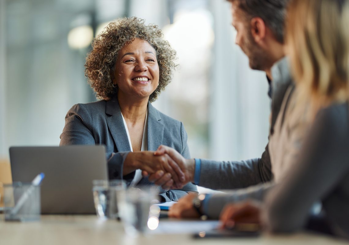 HOA board member shaking hands with an APS Management representative